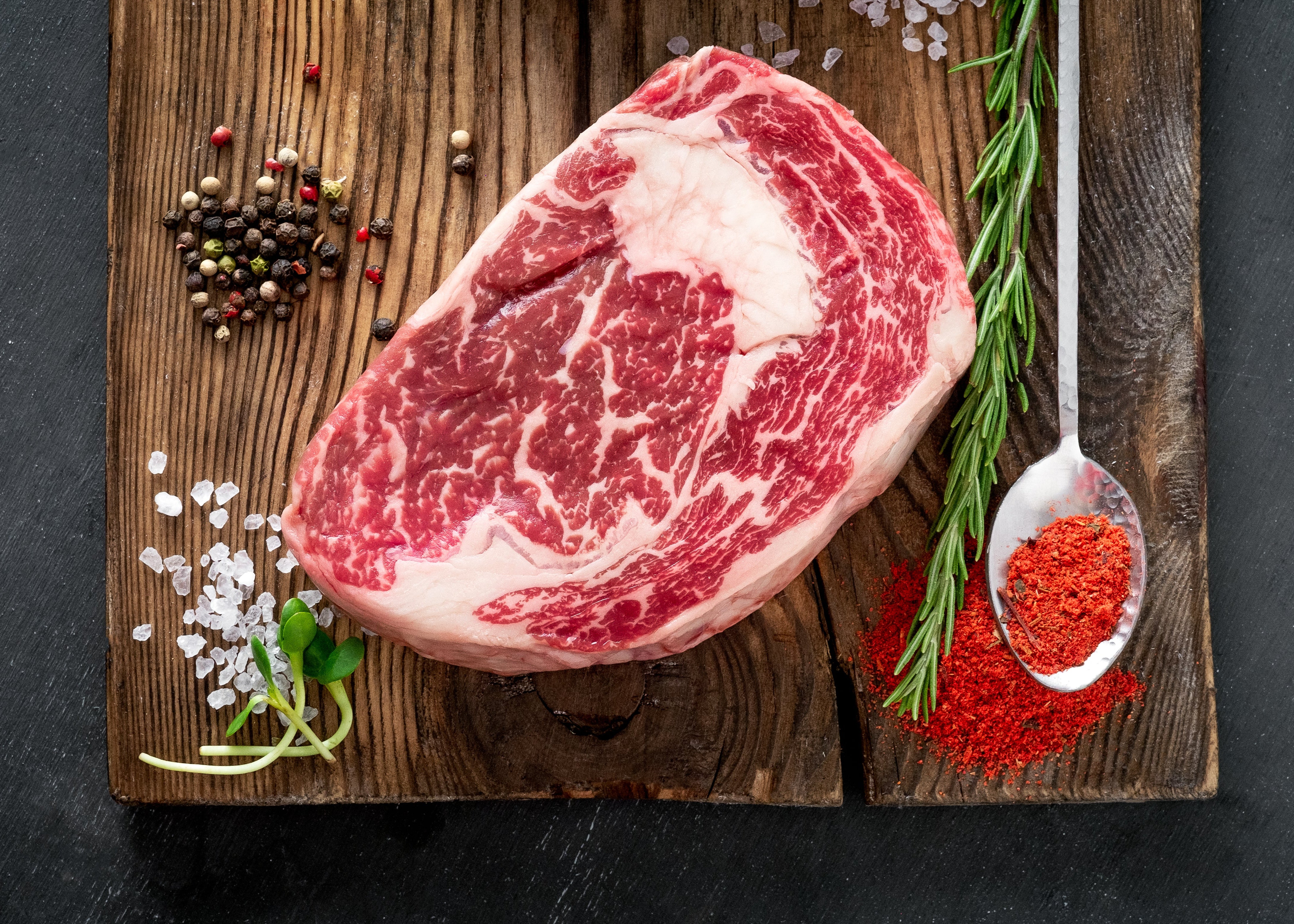 Raw Irongate Cube Roll on a wooden cutting board with spices and herbs